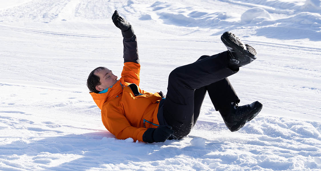 Young Man Falls On Fresh Snowy Landscape