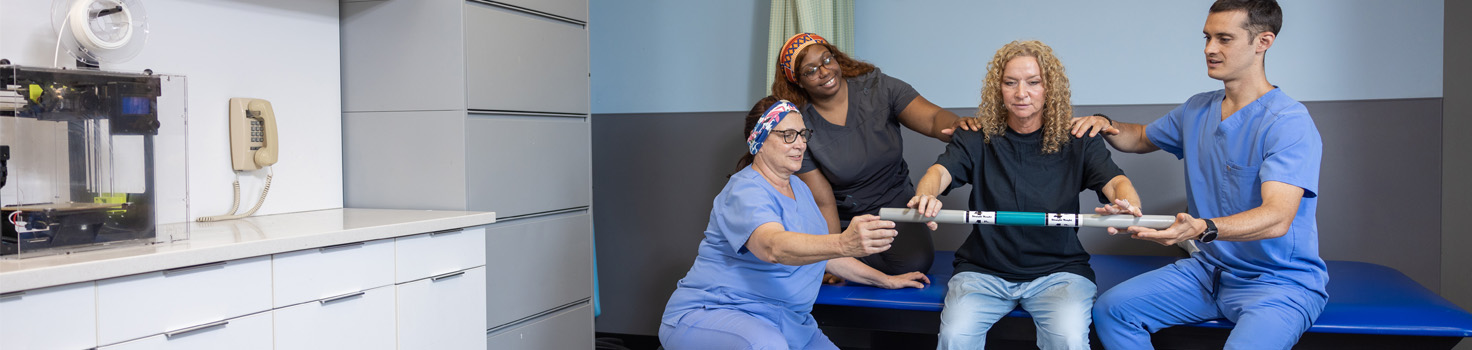 Patient and therapists performing physical therapy