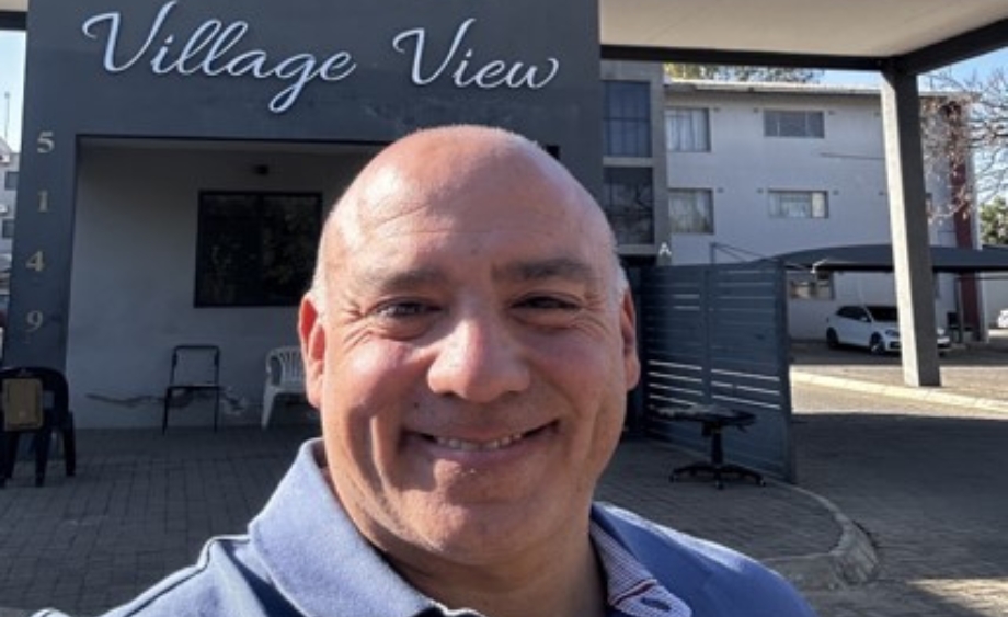 Dr. Franklin Caldera, chief medical officer of Penn Medicine Rehabilitation, an inpatient rehabilitation unit of the Hospital of the University of Pennsylvania, smiles outside of a building in Botswana