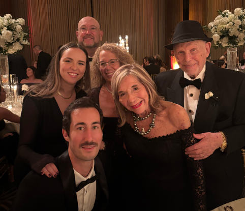 Elaine and Stanley Silverman at their granddaughter's weding pictured smiling with friends and family.
