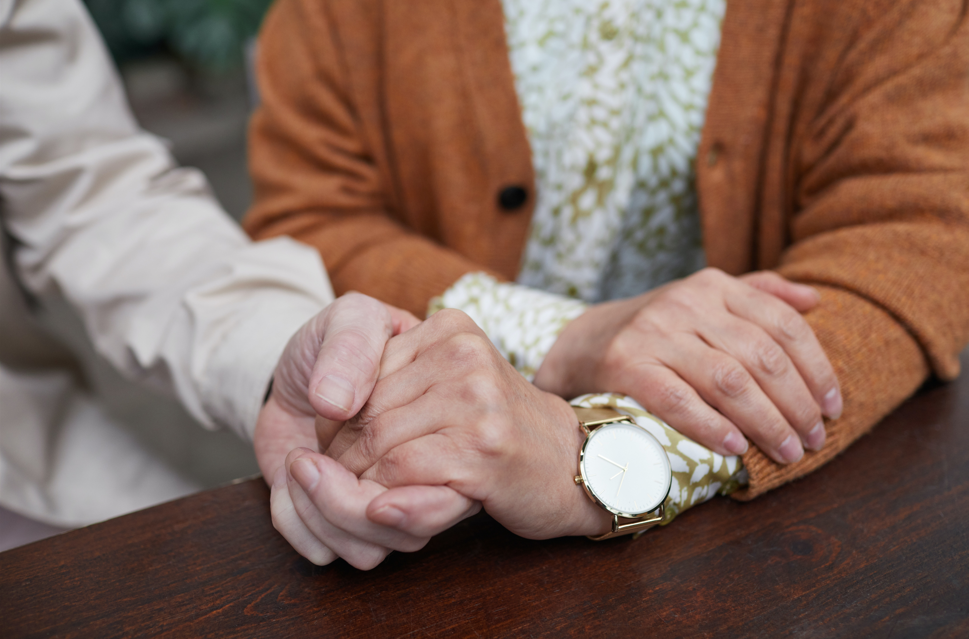 stroke support group meetings. elder couple holding hands in support