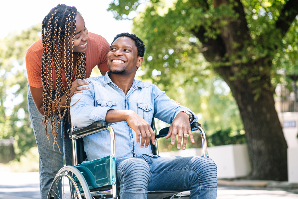 guy and girl looking at each other with guy in a wheelchair