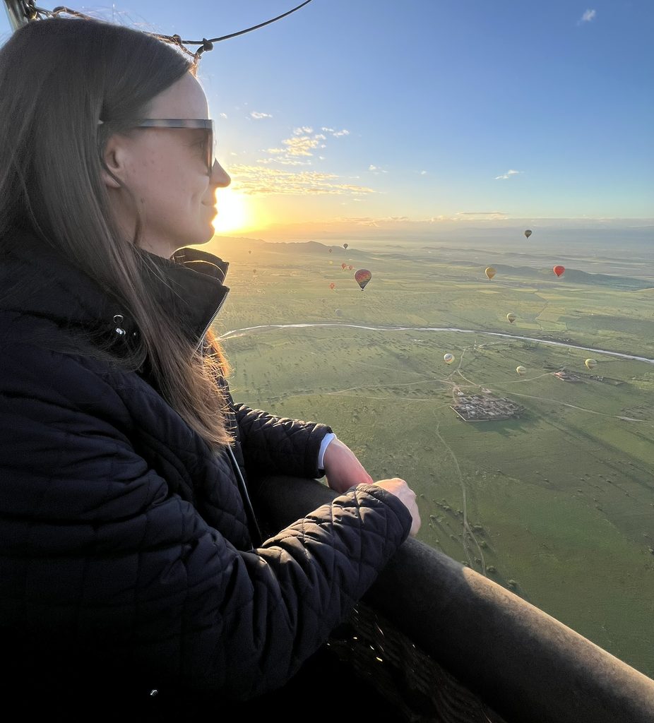elizabeth in a hot air balloon overlooking the sunset from above